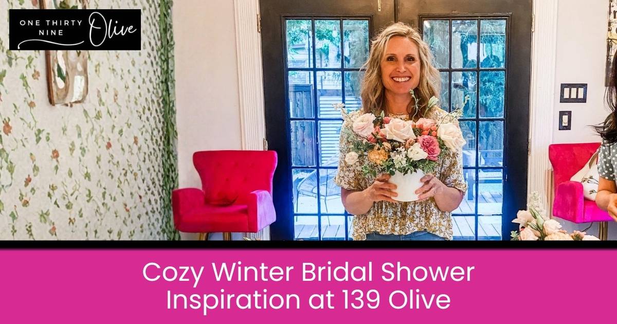 Bridal shower inspiration setting with pink velvet chairs, patterned wallpaper, and an elegant floral centerpiece.